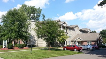 Senior Apartments near Homer NY thumbnail image of ellis pines apartments side view with parking from two plus four property management