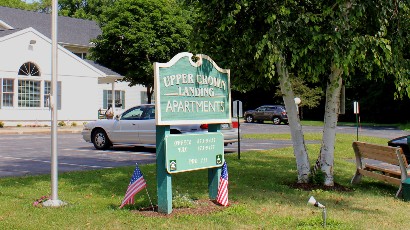 Senior Housing near Marcellus NY thumbnail image of upper crown landing outdoor sign from two plus four management