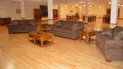 Rent Apartments near Auburn NY thumbnail image of west middle school family apartments community area living room from two plus four management