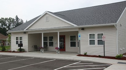 apartments near sidney ny thumbnail image of front entrance with parking lot for sherwood landing family apartments from two plus four management