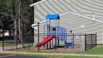 apartments near oswego ny thumbnail image of wine creek II and III family apartment playground sideview from two plus four management