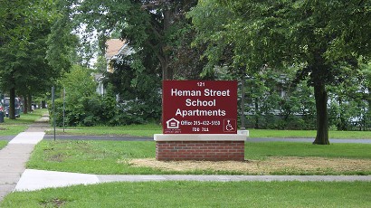 Senior Apartments near East Syracuse NY thumbnail image of 121 heman street school apartments welcome sign 315-432-5150 tdd 711 from two plus four management