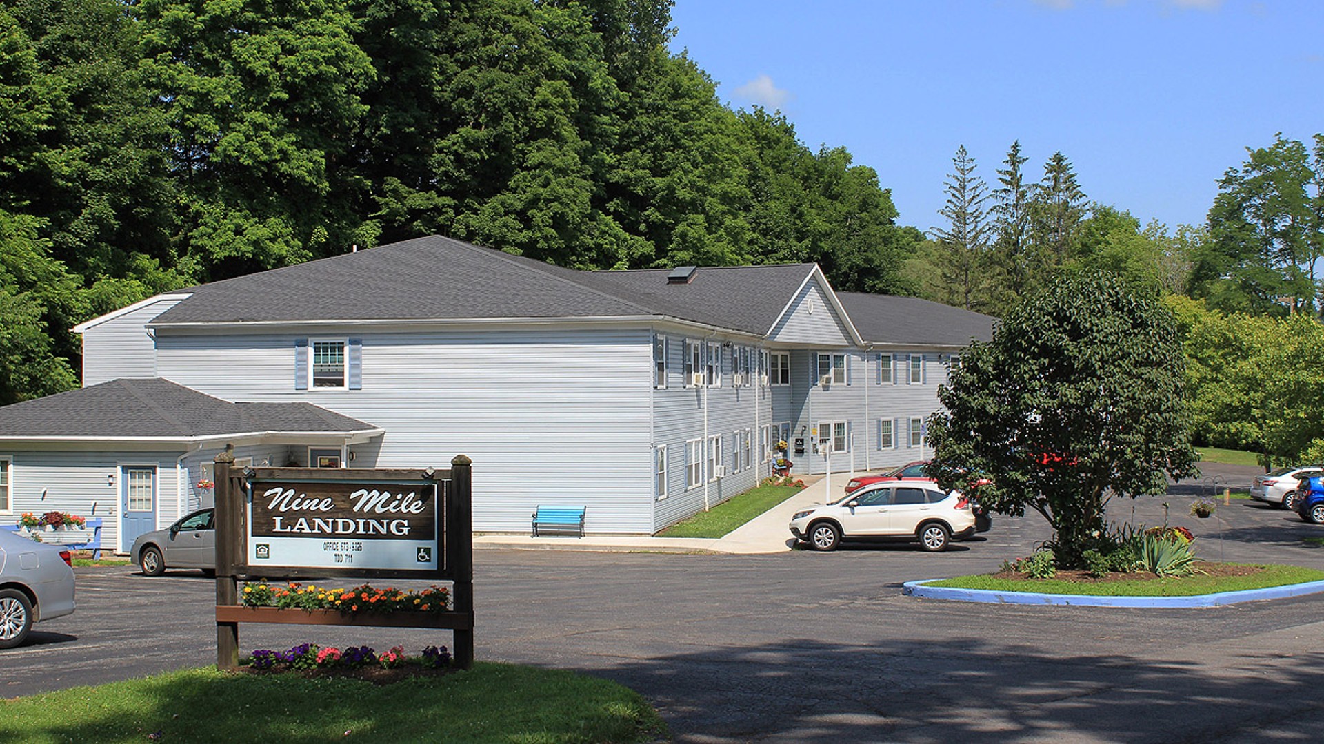 Senior Apartments near Marcellus NY image of nine mile landing apartments outdoor sign from two plus four management