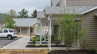 Apartments near Wellsville NY thumbnail image of highland pointe family apartments entrance from two plus four management