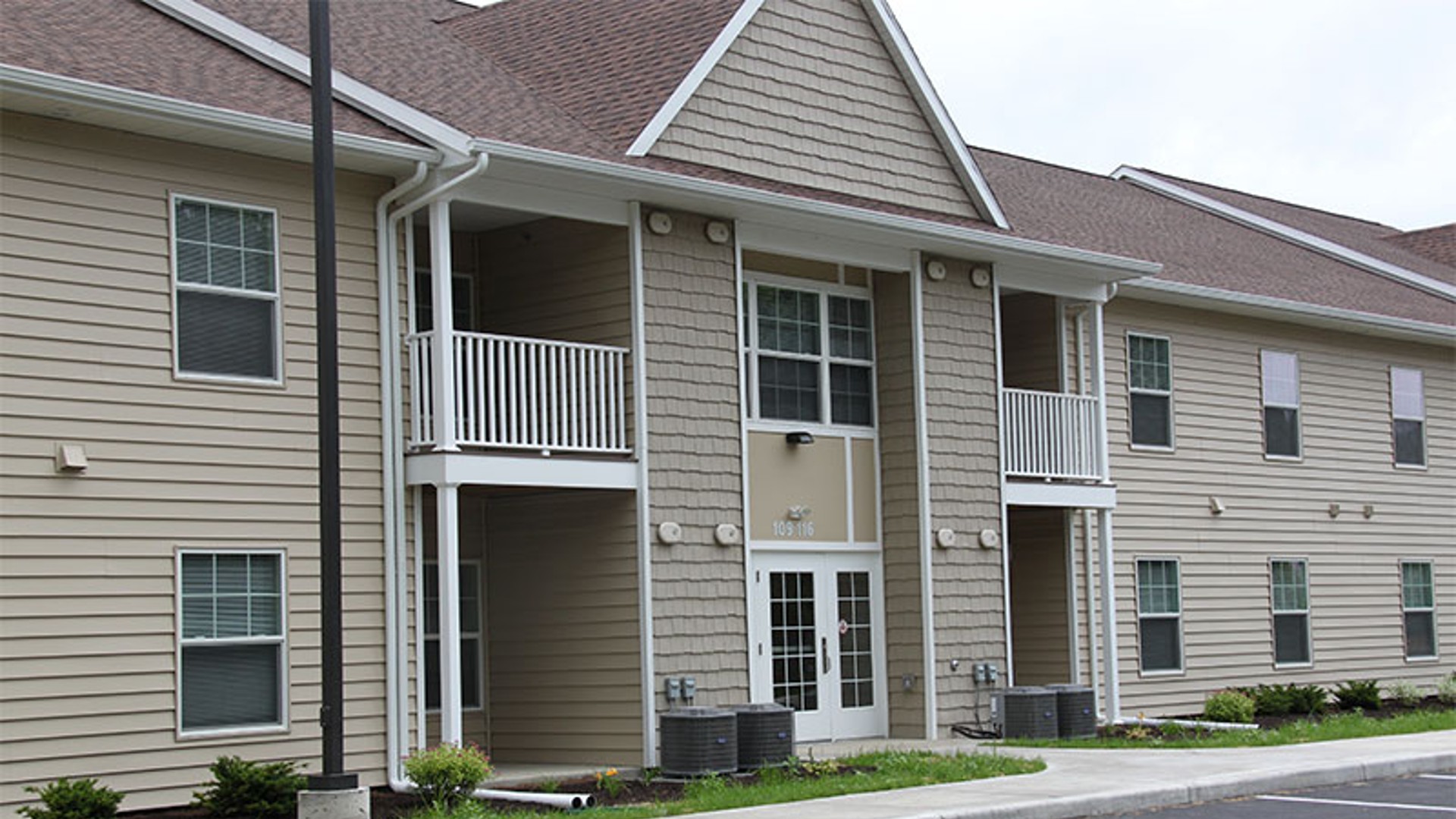 apartments near norwich ny image of the side view for Cobblers Square family apartments from two plus four management