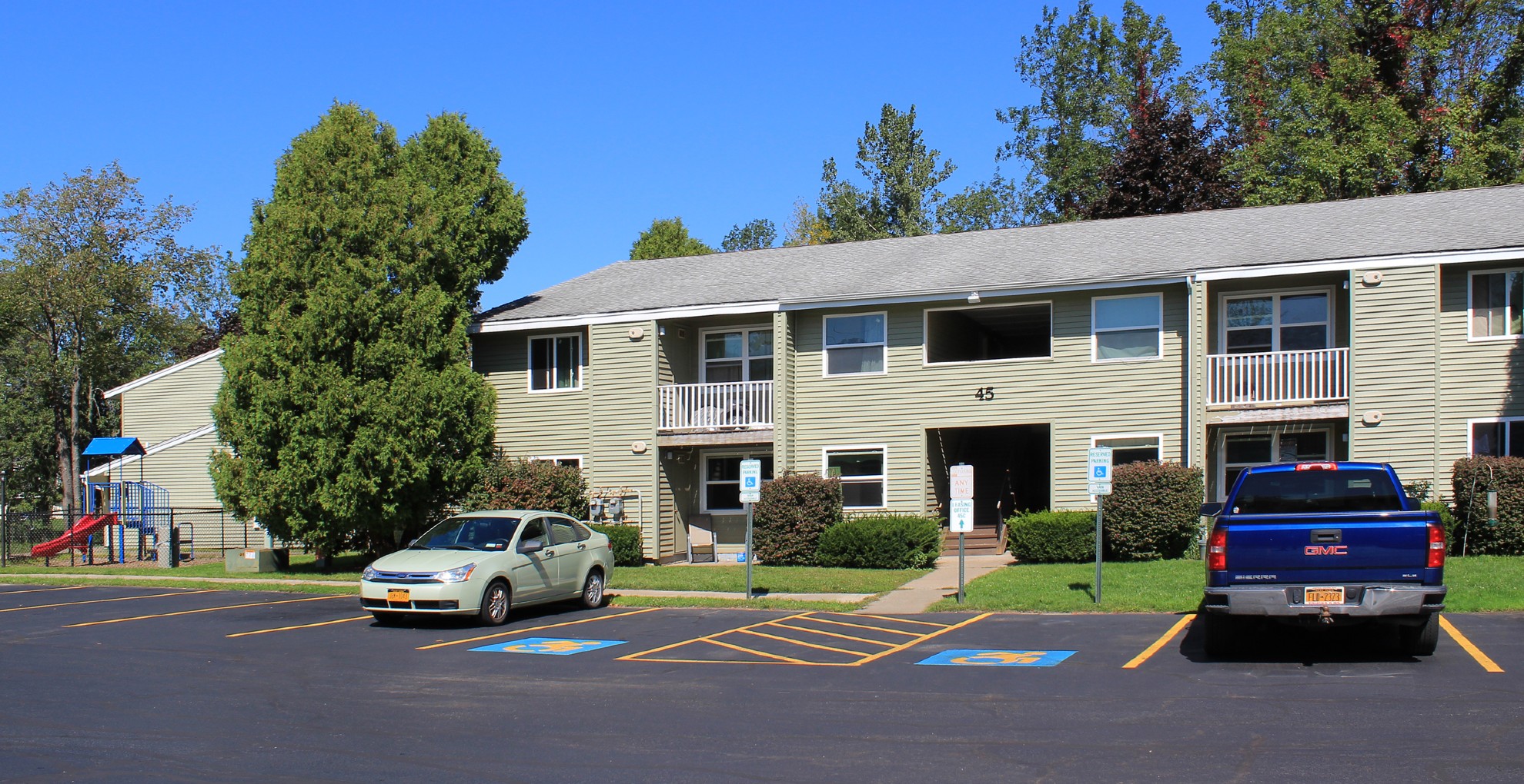 apartments near oswego ny image of wine creek II and III family apartments building with parking from two plus four management