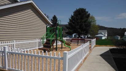 Apartments near Wellsville NY thumbnail image of highland pointe family apartments playground from two plus four management