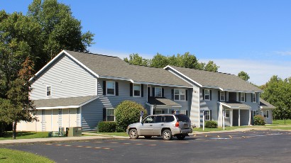 Apartments near Sackets Harbor NY thumbnail image of side view for shipyard family apartments with parking lot for two plus four management