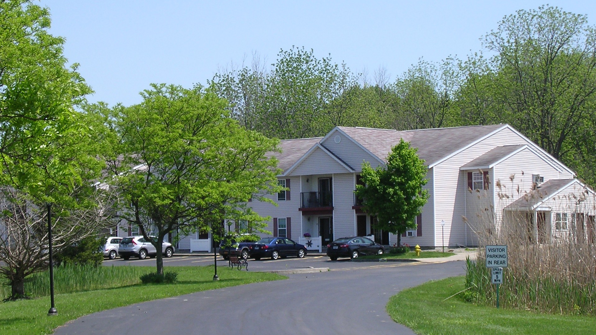 Senior Housing near East Syracuse NY image of colonial village senior apartments street view from two plus four management