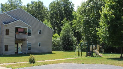 Senior Housing near Camillus NY thumbnail image of connelly acres apartments backyard with playground from two plus four property management