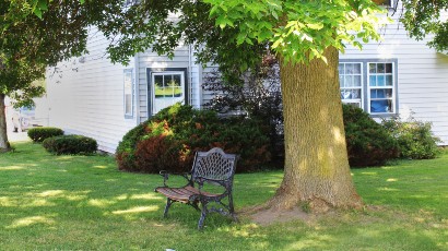 Apartments near Lowville NY thumbnail image of lewis and lowville heights family apartments backyard bench from two plus four management