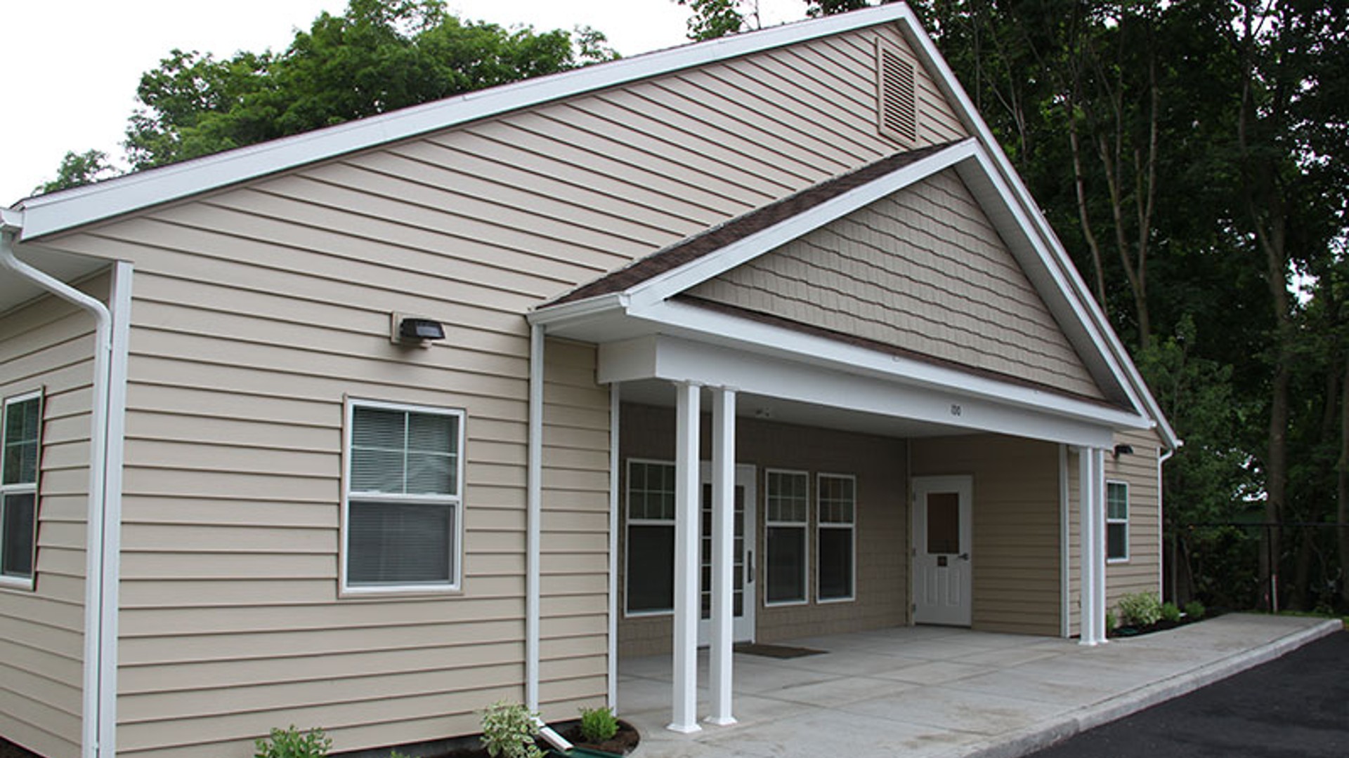 apartments near norwich ny image of the back entrance for Cobblers Square family apartments from two plus four management