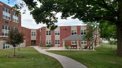 Senior Apartments near East Syracuse NY thumbnail image of heman street school apartments side entrance from two plus four management