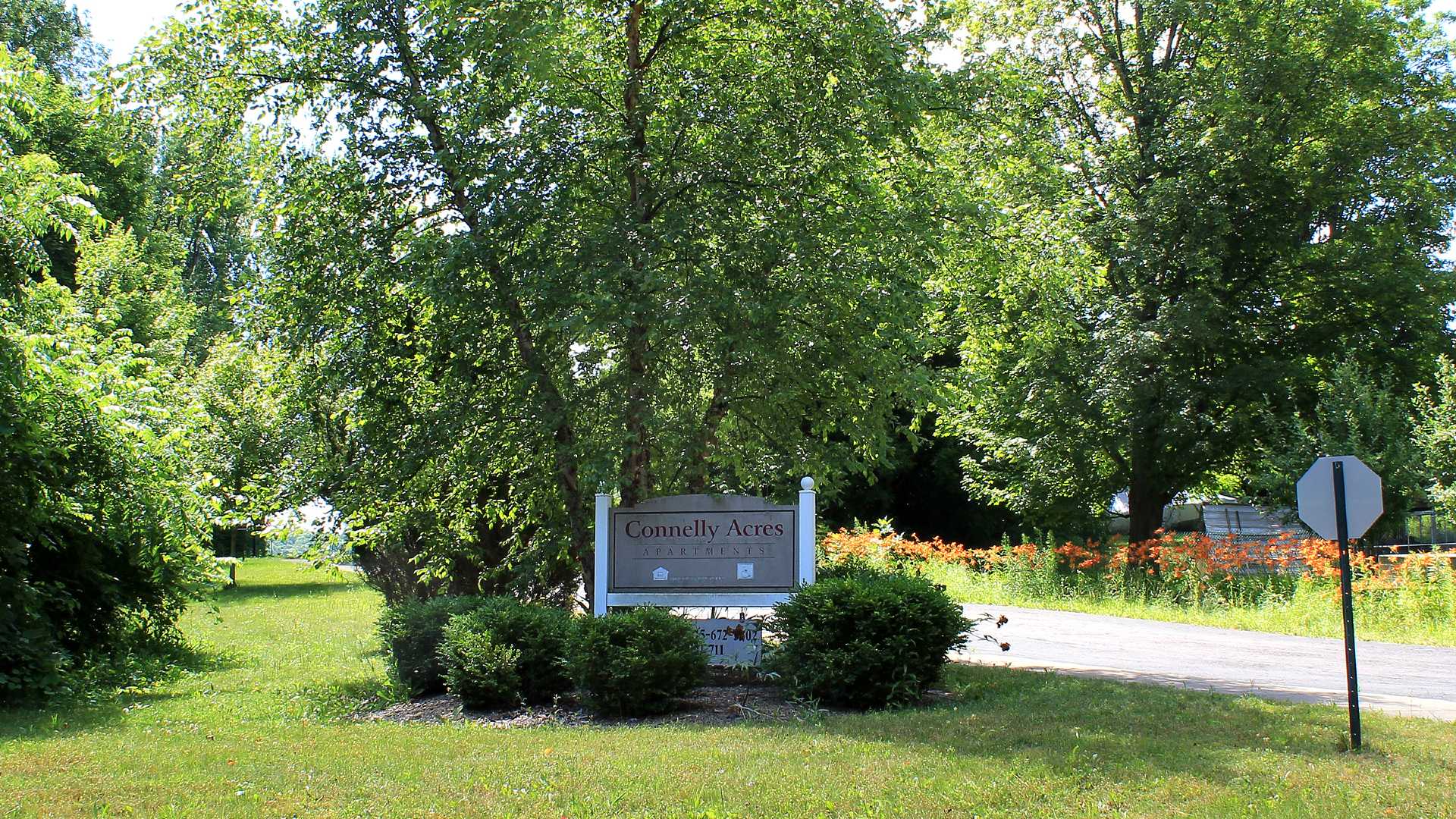 Senior Housing near Camillus NY image of connelly acres apartments welcome sign from two plus four property management