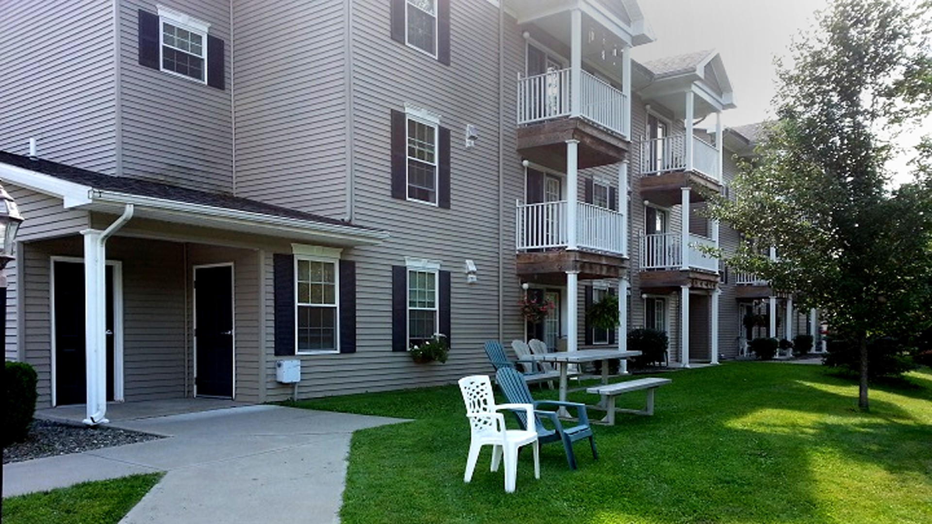 Senior Apartments near Homer NY image of ellis pines apartments back entrance from two plus four property management