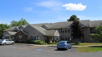 Senior Housing near Camillus NY thumbnail image of connelly acres apartments with parking from two plus four property management