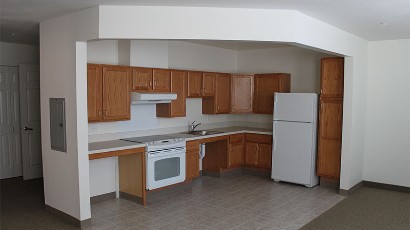 Senior Apartments near East Syracuse NY thumbnail image of heman street school apartments kitchen area from two plus four management