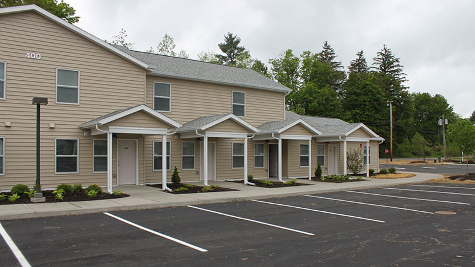 Apartments near Wellsville NY image of highland pointe family apartments with parking from two plus four management