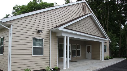 apartments near norwich ny thumbnail image of the back entrance for Cobblers Square family apartments from two plus four management