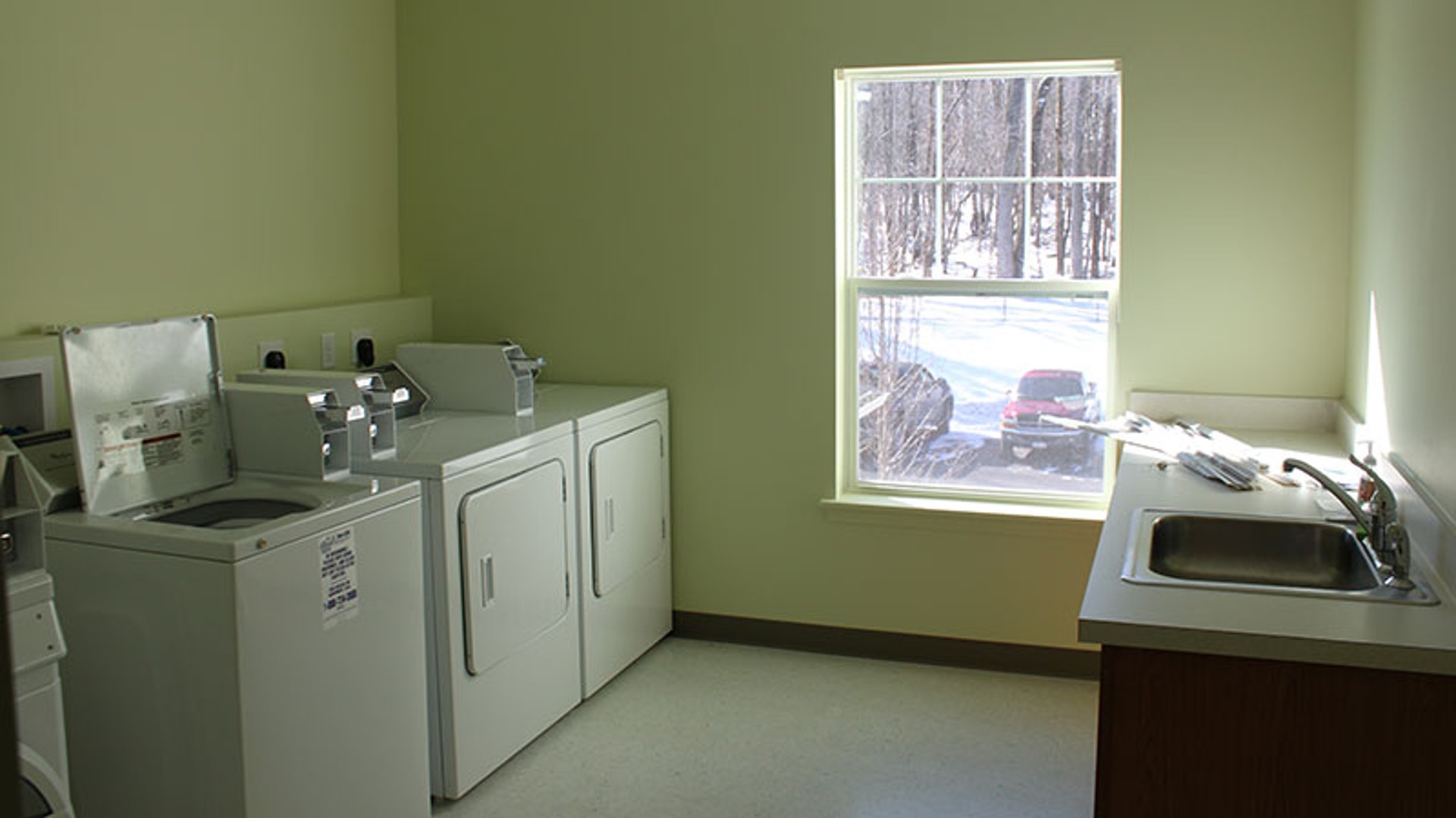 Senior Apartments near Central Square NY image of waterworks landing laundry room from two plus four management