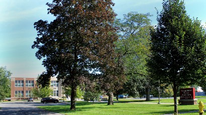 Senior Apartments near East Syracuse NY thumbnail image of heman street school apartments entrance from two plus four management