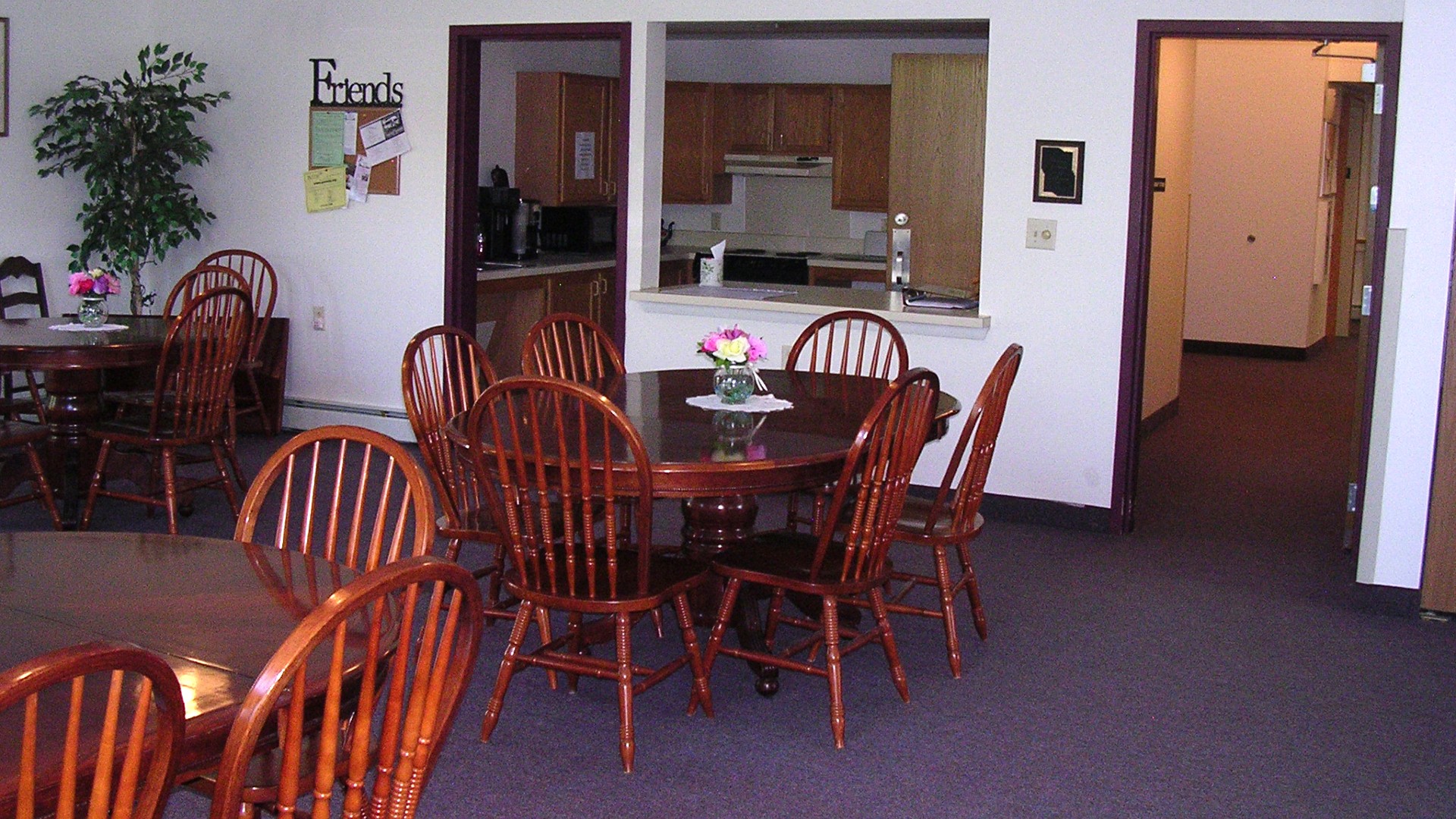 Senior Housing near East Syracuse NY image of colonial village senior apartments community room and kitchen from two plus four management