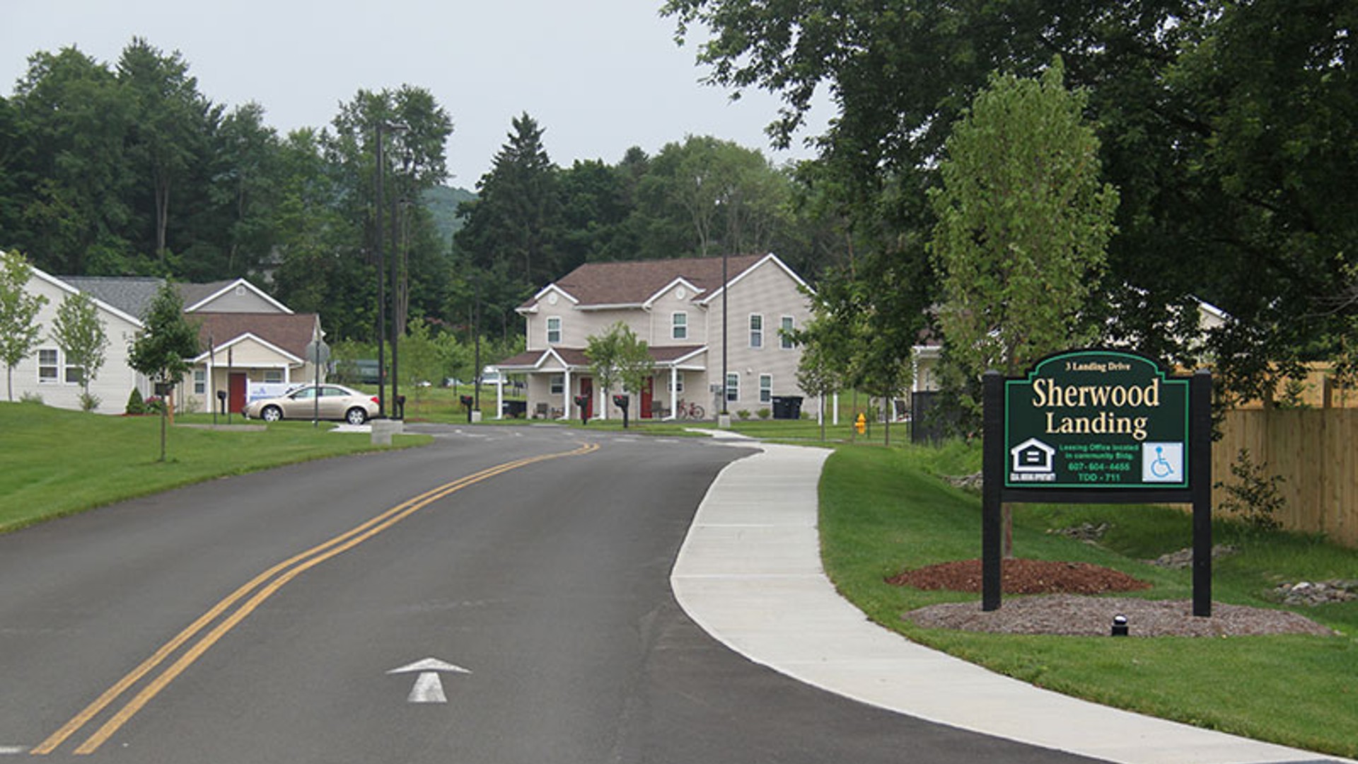 Apartments near Sidney NY image of sherwood landing apartment entrance for two plus four management