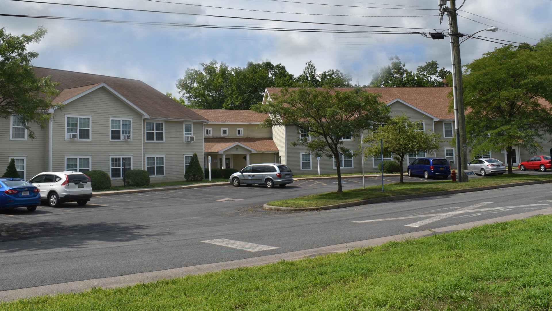 apartments near seneca falls ny exterior view image of prospect hill senior apartments with parking lot from two plus four management