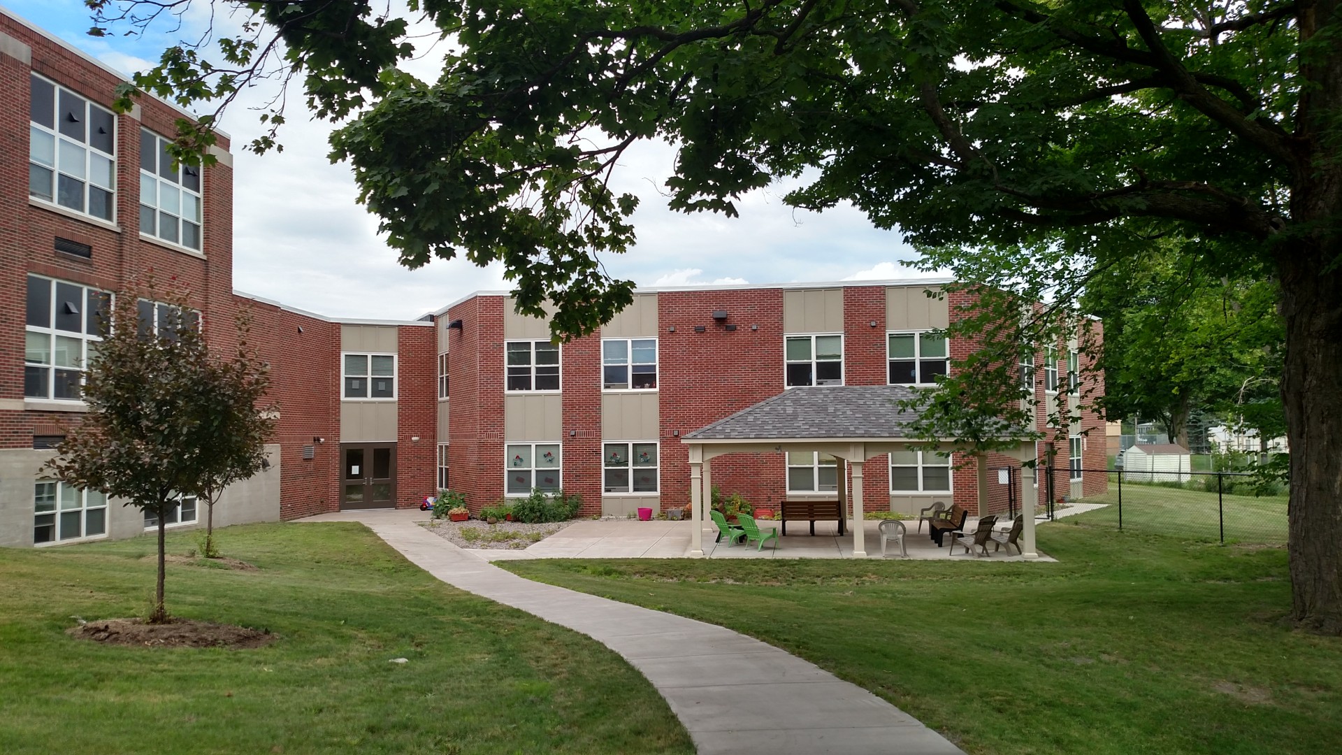 Senior Apartments near East Syracuse NY image of heman street school apartments side entrance from two plus four management