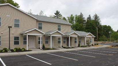 Apartments near Wellsville NY thumbnail image of highland pointe family apartments with parking from two plus four management